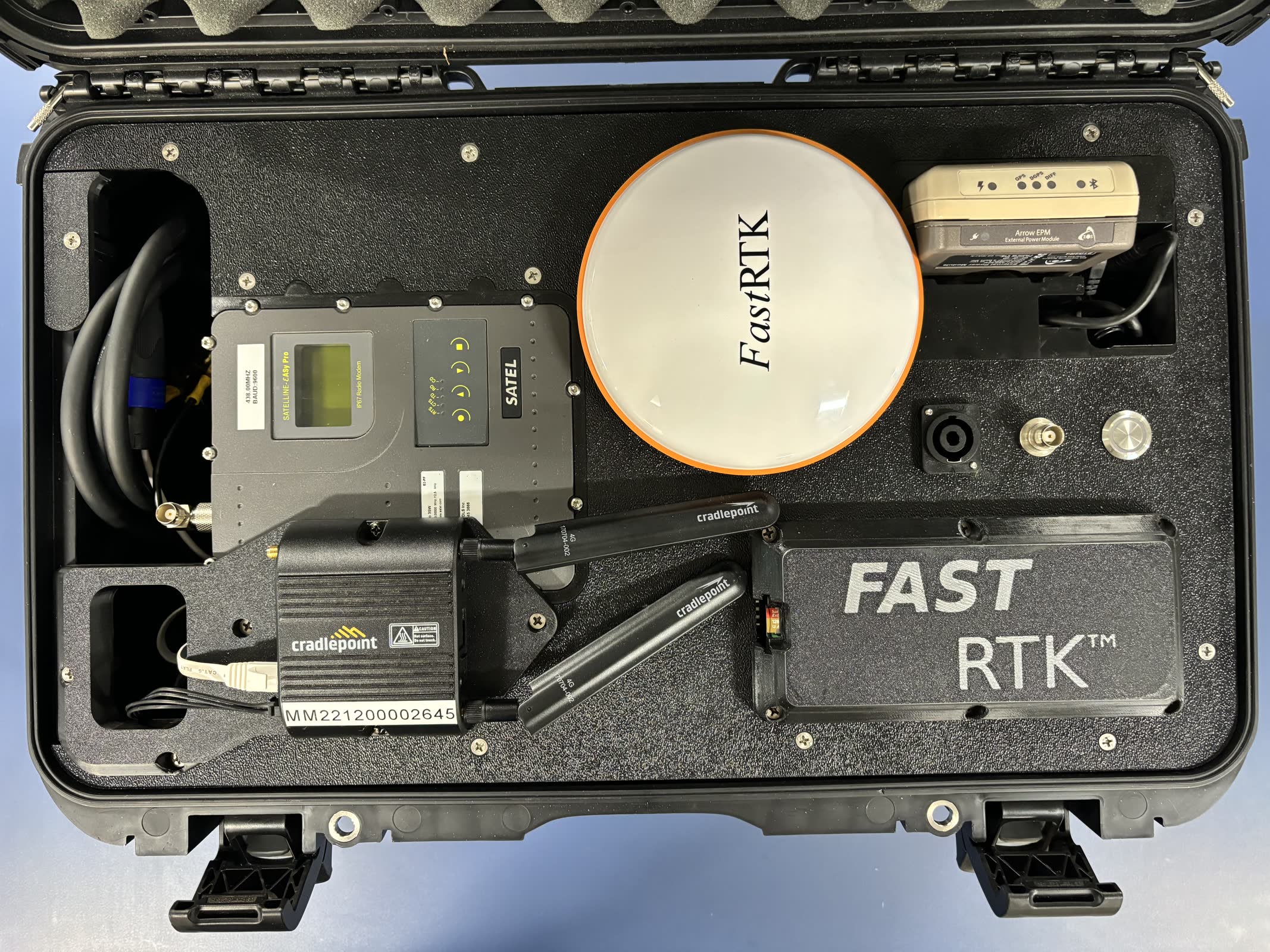 The FastRTK mobile base station in its transport case, with receiver, radio and antenna